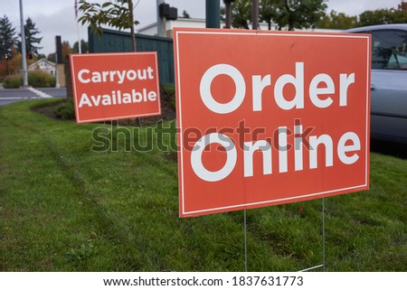 Order Online and Carryout Available signs outside a restaurant during the coronavirus pandemic.