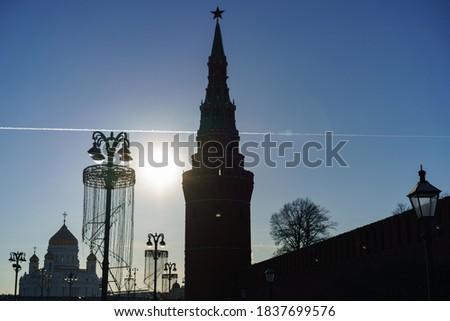 Moscow cityscape in the bright sunny spring day. Cathedral of Christ the Saviour and Kremlin Tower, Red Kremlin wall, creative street lanterns. Blue sky. Back lit photography
