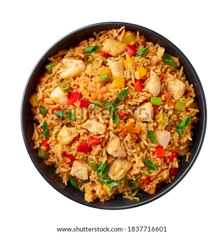 Schezwan Chicken Fried Rice in black bowl isolated on white background. Szechuan Rice is indo-chinese cuisine dish with bell peppers, green beans, carrot, chicken breasts. Top view Royalty-Free Stock Photo #1837716601