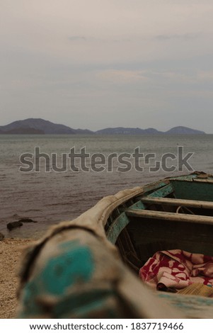 Old Wooden Boat on the Background of Cloudy Seascape