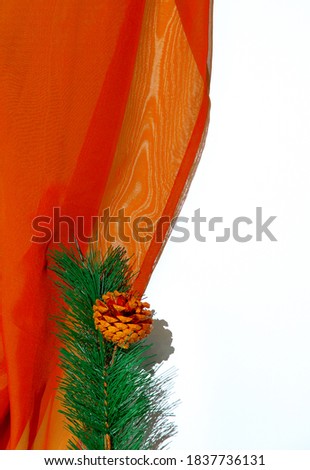 Christmas tree twig and textiles on white shadows space. Merry Christmas / Happy New Year holidays celebration concept.