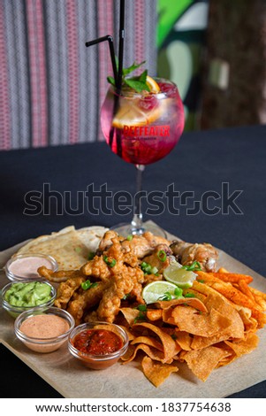 Appetizing Mexican meat is beautifully served on a plate with vegetables and fries