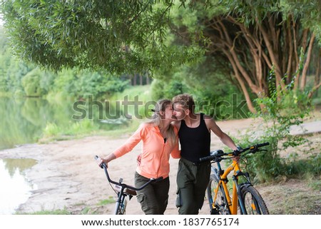 the Couple in love on bikes in the woods in the park