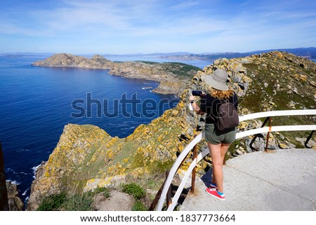 Woman taking photos in the Cies Islands Royalty-Free Stock Photo #1837773664