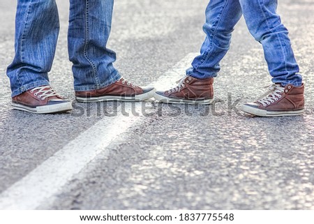Beautiful feet of parent and child on the road in the park on nature travel