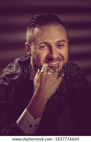 Closeup portrait of young handsome laughing businessman dreaming. image toned in warm colors in retro style