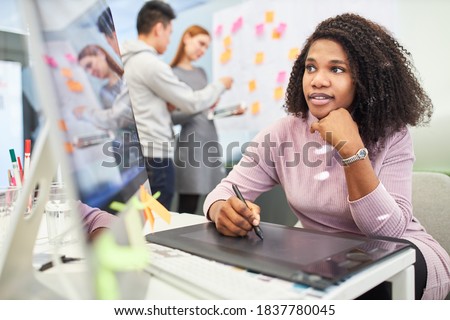 African woman as graphic designer in training on tablet computer