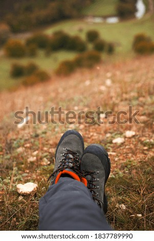 Photo of womans legs on a hill in fall