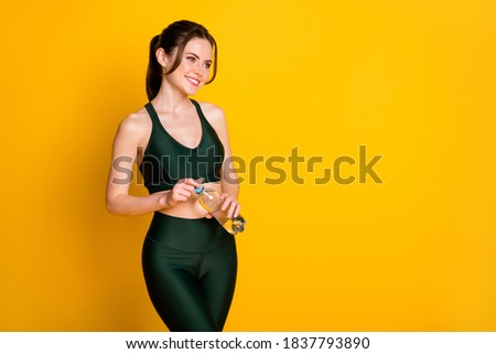 Portrait of her she nice pretty cheerful sportive slim slender girl drinking water enjoying isolated on vibrant yellow color background