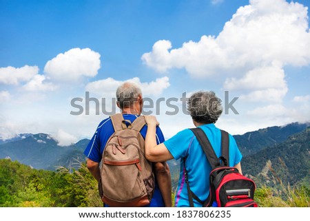 Rear view  Senior  couple hiking on the mountain  Royalty-Free Stock Photo #1837806235