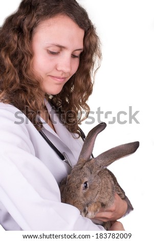 A portrait of a female vet holding a rabbit