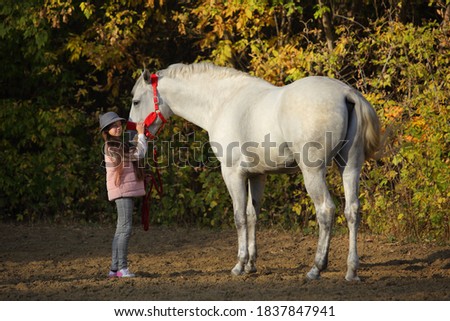 Tambov, Russia, October 20, 2020: Child girl and andalusian dressage horse at the official rehearsal of the Pokrovskaya fair exhibition