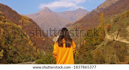 A girl with yellow outfit in nature. Yellow nature and girl. Autumn picture.