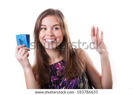 Pretty young girl in colorful dress with credit cards