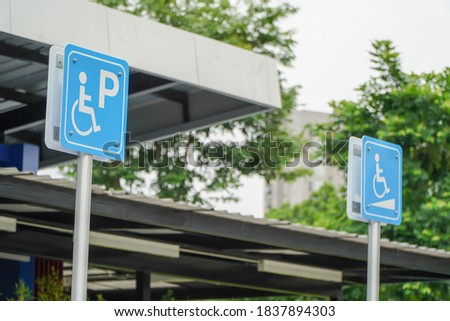Handicapped parking sign with green background wheelchair up and down sign
