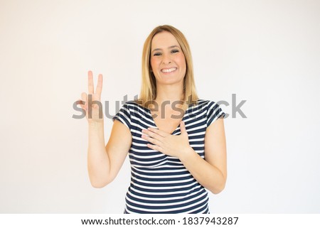 Beautiful young woman happy and excited expressing winning gesture. Successful pretty woman celebrating victory, triumphant, studio shot over white background