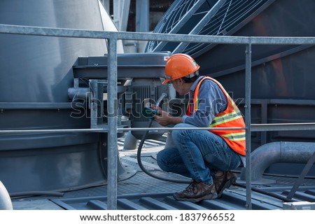 Engineer under checking the industry cooling tower air conditioner is water cooling tower air chiller HVAC of large industrial building to control air system. Royalty-Free Stock Photo #1837966552