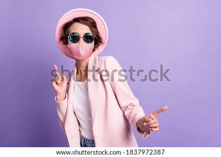 Photo of funny pretty young woman dancing wear medical mask coat hat glasses isolated purple color background Royalty-Free Stock Photo #1837972387