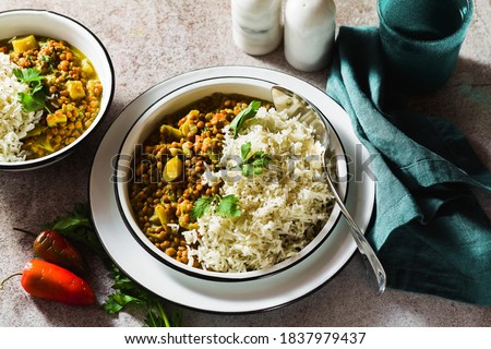 indian lentil dhal with vegetables and basmati rice on the table. healthy vegan Ayurvedic cuisine Royalty-Free Stock Photo #1837979437