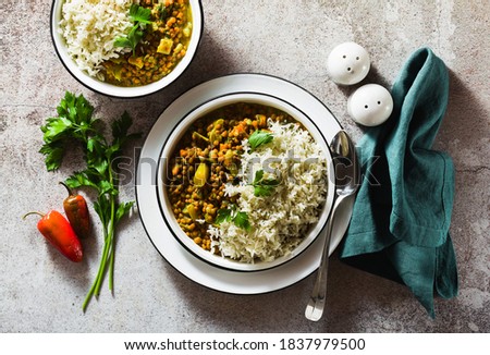 indian lentil dhal with vegetables and basmati rice on the table. healthy vegan Ayurvedic cuisine Royalty-Free Stock Photo #1837979500