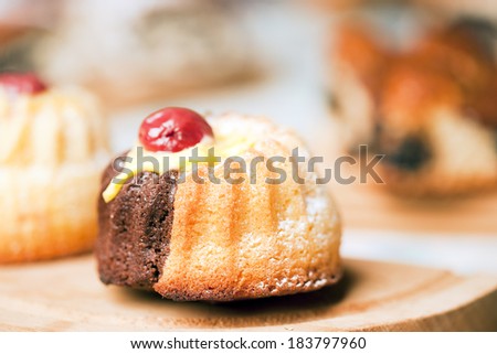 Chocolate and vanilla muffin cake with cherry