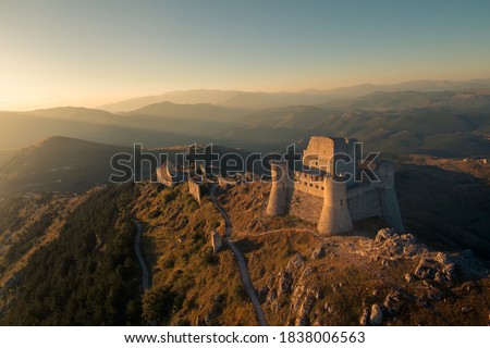 Castle of Rocca Calascio with mountains at sunrise. Royalty-Free Stock Photo #1838006563