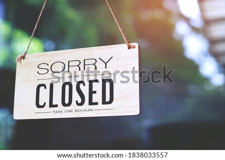sorry closed sign on shop door. Text on cafe front or restaurant hang on door at entrance. vintage tone style. Royalty-Free Stock Photo #1838033557