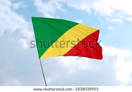 Flag of the Republic of the Congo in front of blue sky