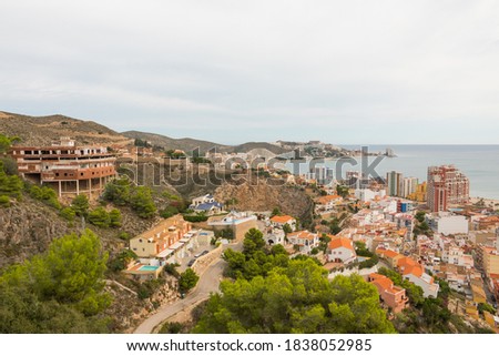 Cullera city from an aerial view. Beautiful panorama of the city, the mountains and the mediterranean sea in the background. Photography taken from the historic Castle.