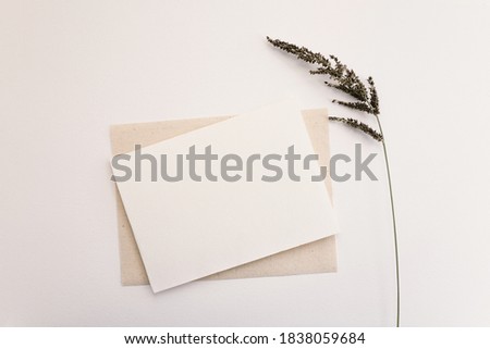 Blank paper card with dry flower. Copy space for your text, flat lay, top view