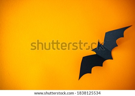 Halloween decorations on white background. Halloween concept. Halloween holiday decorations. black paper bats flying over orange background