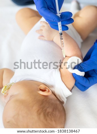 Vaccination baby, injection in the arm. Selective focus. People.