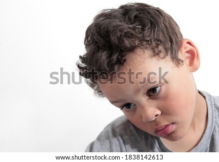 poor boy in poverty with no help alone and all by himself on white background stock photo