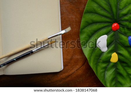 Painting with acrylics and a leaf Royalty-Free Stock Photo #1838147068