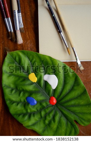 painting with acrylics and a leaf eco friendly Royalty-Free Stock Photo #1838152138