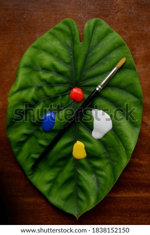 painting with acrylics and a leaf eco friendly Royalty-Free Stock Photo #1838152150