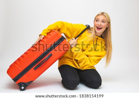Girl student beautiful suitcases travel to rest close-up happiness joy
