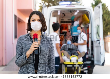TV news reporter is making reportage about a virus epidemic in the hospital Royalty-Free Stock Photo #1838163772
