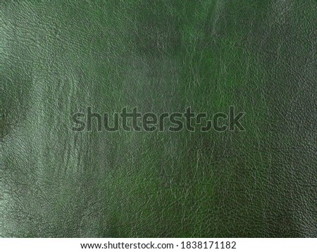 Genuine dark green cattle leather texture background. Macro photo