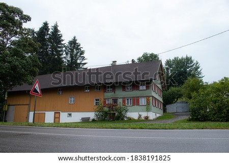 A house on a mountain near Isny in the Allgäu, Baden-Württemberg, Germany on a very cloudy and rainy day in 2020