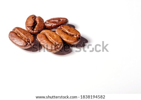 Heap of fresh roasted coffee beans isolated on white background as package design elements