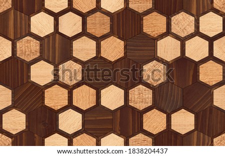 Wooden hexagonal tiles. Natural oak brown parquet floor with honeycomb pattern. Wood texture background. 