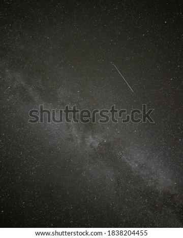 Looking directly up into the sky, galaxy with the bright and beautiful milky way visible surrounded by dark, starry skies. 