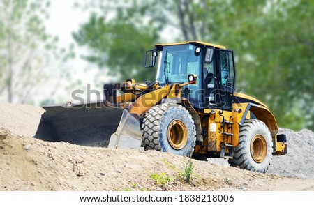a big backhoe with a blurred background Royalty-Free Stock Photo #1838218006
