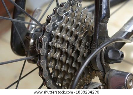 Gears, frame and the wheel of a bike.