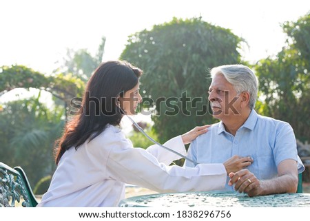Nurse listening to heartbeat of old patient Royalty-Free Stock Photo #1838296756