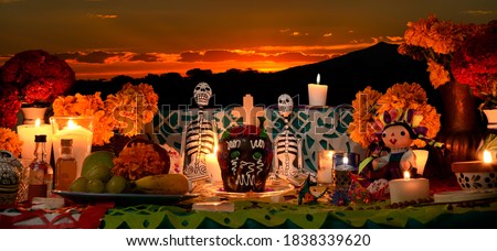Mexican day of the dead altar at sunset at dim candlelight Royalty-Free Stock Photo #1838339620