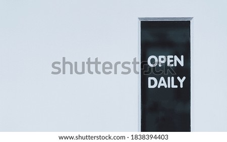 restaurant opening sign on white wall