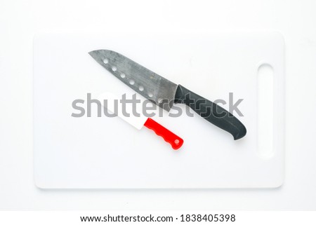 A picture of kitchen knife and toy knife on chopping board for my ambition concept.