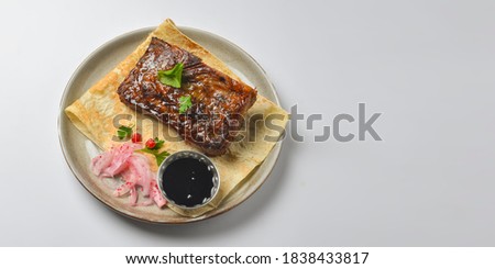 Turkish and Arabic traditional grilled steak and grilled vegetables with lavash bread and sauce served over white background. Georgian cuisine concept.